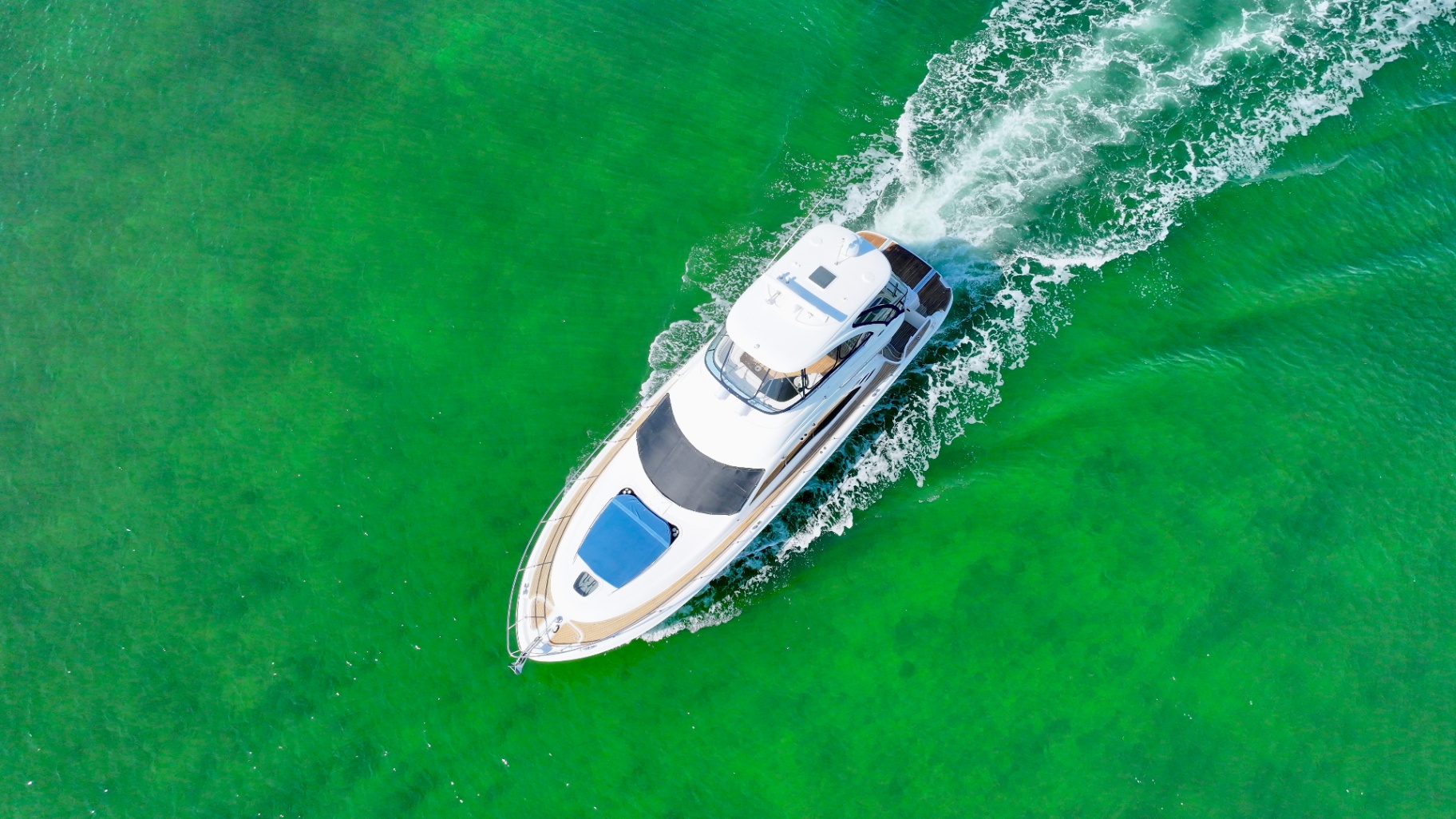 Lady Skarlet crossing bright green Biscayne Bay water