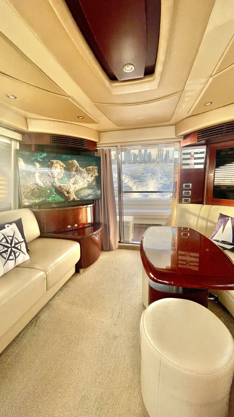 Lounge area of Lady Skarlet with television and aft door to the deck